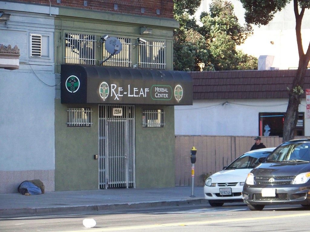 Storefront of a herbal cannabis center on a city street
